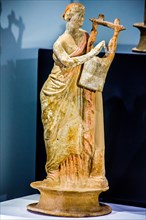 Ceramic statue of a woman playing the lyre