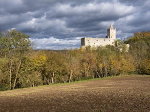 Rudelsburg castle ruins in the Saale valley in autumn under dark clouds