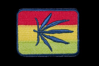 Patch with Jamaican national colours and a hemp leaf in the centre