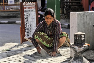 Nepalese woman repairing the road