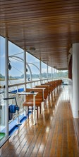Wood-panelled outside deck of an excursion boat