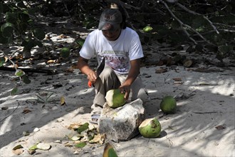 Man opening a coconut