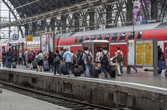 Group of travellers with their luggage on a platform