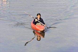 Schoolgirl with paddle boat