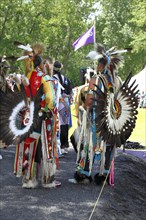 Native Americans with colorful dress at a Pow Wow