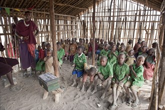 Children in a primary school class with a teacher, Masai, village of Kiloki