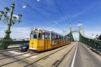 Yellow tram and bridge gate on the Freedom Bridge