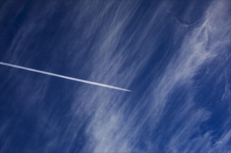 Cloudy sky with contrails
