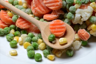Frozen vegetables with cooking spoon