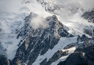 Cloud-covered mountain with snow and glacier