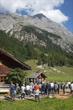Mass celebration on Almkirtag in front of the wooden chapel in the mountain village of Eng