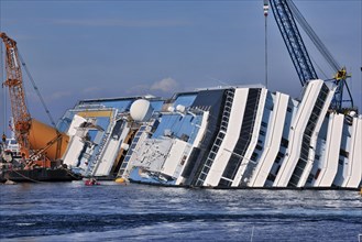 View of the upper deck of the capsized cruise ship with the name Costa Concordia visible