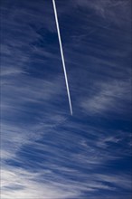 Cloudy sky with contrails