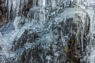 Icicles forming an icefall in the mountain in winter. France