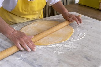 Woman rolling pasta dough