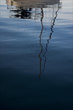 Reflection of a sailboat in the water