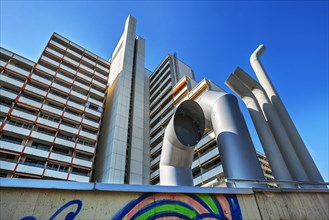 High-rise building with concrete balconies and ventilation pipes