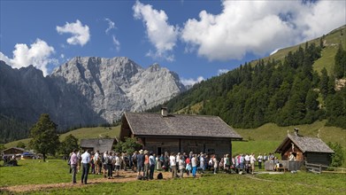 Mass celebration on Almkirtag in front of the wooden chapel in the alpine village of Eng