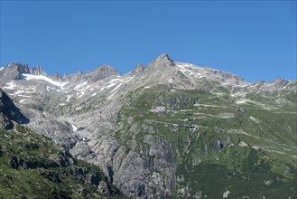 Mountain massif of the Rhone glacier with serpentines of the Furka Pass road