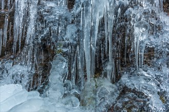 Icicles forming an icefall in the mountain in winter. France