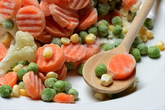 Frozen vegetables with cooking spoon