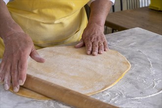 Woman rolling pasta dough