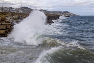 Strong swells during storm break on seawall in Sanremo