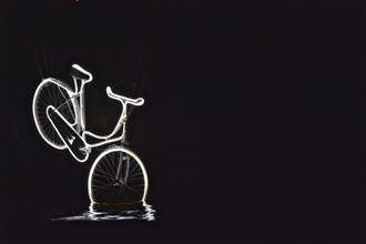 Neon-lit bicycle dives into the water of a canal