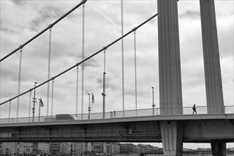 Pedestrian walking over steel suspension bridge