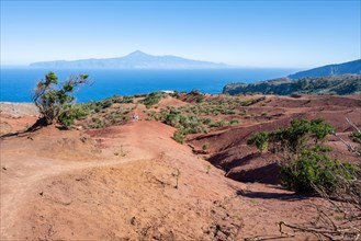 Red desert landscape at the skywalk Mirador de Abrante with view of Tenerife