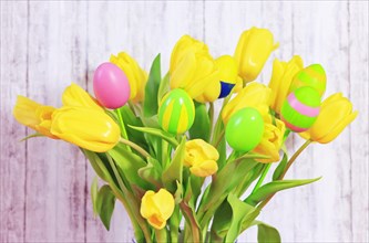 Bouquet of tulips with Easter eggs on a stick