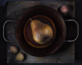 Still life with pear in iron pan