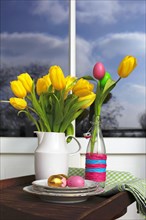 Bouquet of tulips and Easter eggs on a balcony