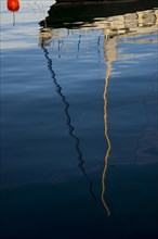 Reflection of a sailboat in the water