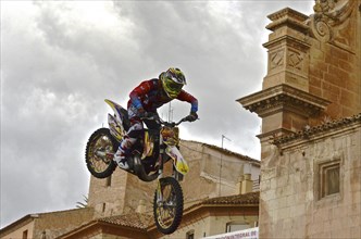 Motorbike artist flies over roofs of the old town