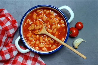 White beans with tomato sauce in pot