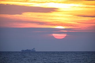 Sunrise with container ship on the Mediterranean Sea in Porto Maurizio