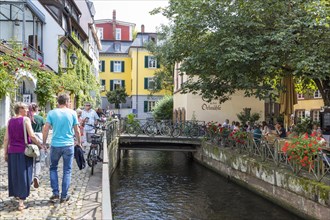 Gewerbekanal in the former craftsmen's quarter between Gerberau and Insel with historic buildings and street cafe