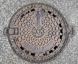 Manhole cover with coat of arms and inscription City of Bad Muskau