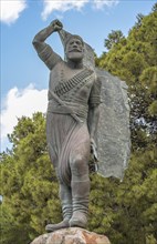 Statue and monument of Spyros Kayales with Greek flag