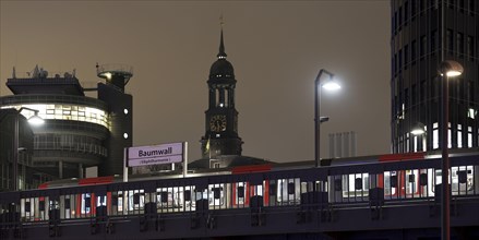 Baumwall underground station with the spire of St Michaelis church at night