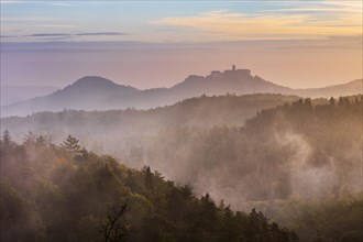 View from the Rennsteig over the Thuringian Forest to Wartburg Castle in the first morning light in autumn