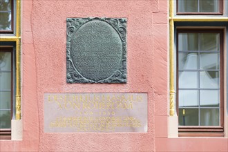 Stone plaque on the facade in today's Haus zum Walfisch about the stay of Erasmus of Rotterdam