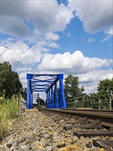 Blue steel bridge along the railway line