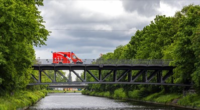 Emergency ambulance crossing a steel bridge