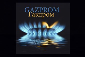 Gas flame with Gazprom logo reflected in the water