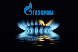 Gas flame with Gazprom logo reflected in the water