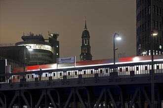 Baumwall underground station with the spire of St Michaelis church at night