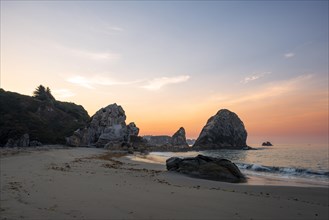 Sandy beach beach Harris Beach with rocks at sunrise