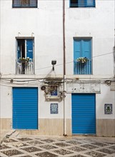 Blue doors and windows on white facade